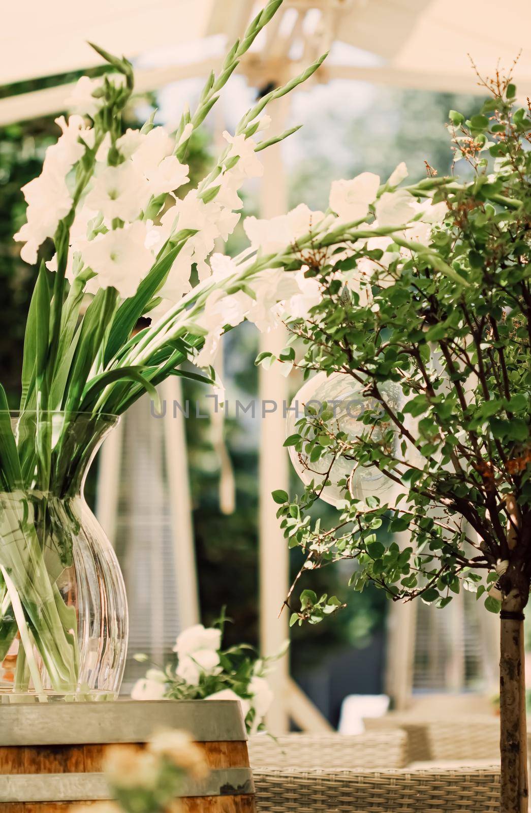 Floral wedding decoration in a restaurant outdoors in summer.