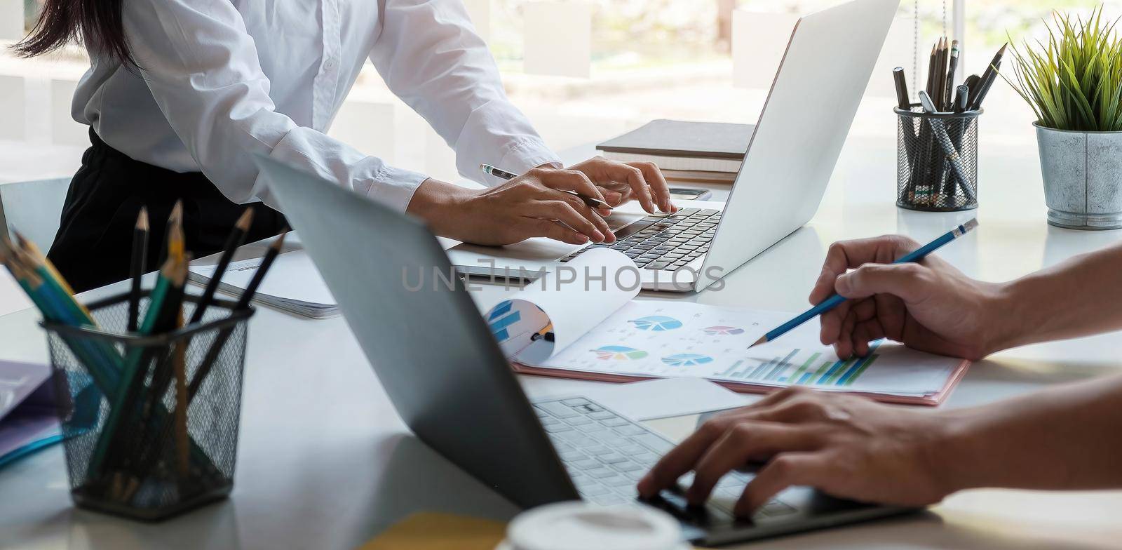 Business team analyzing income charts and graphs with modern laptop computer. Close up.Business analysis and strategy concept..