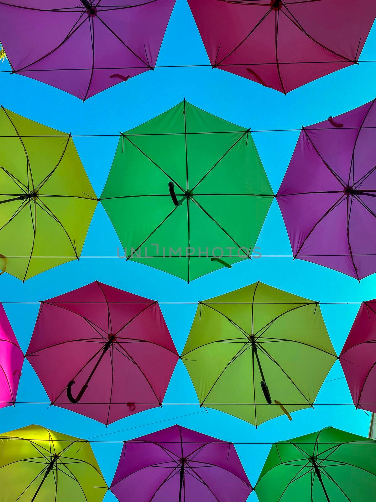 Low Angle View Of Colorful Umbrellas Hanging Outdoors - stock photo by kaliaevaen