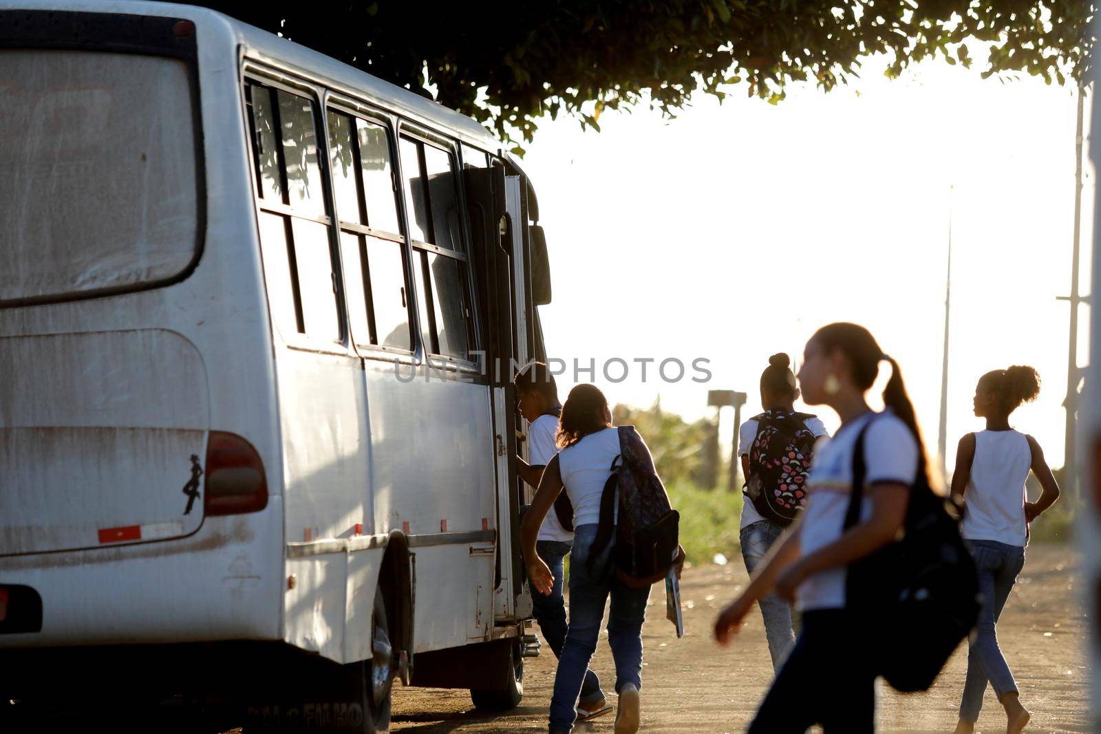 santo antonio de jesus, bahia, brazil - august 7, 2019: public school students are seen along the school transport bus in the street area in the city of Santo Antonio de Jesus.