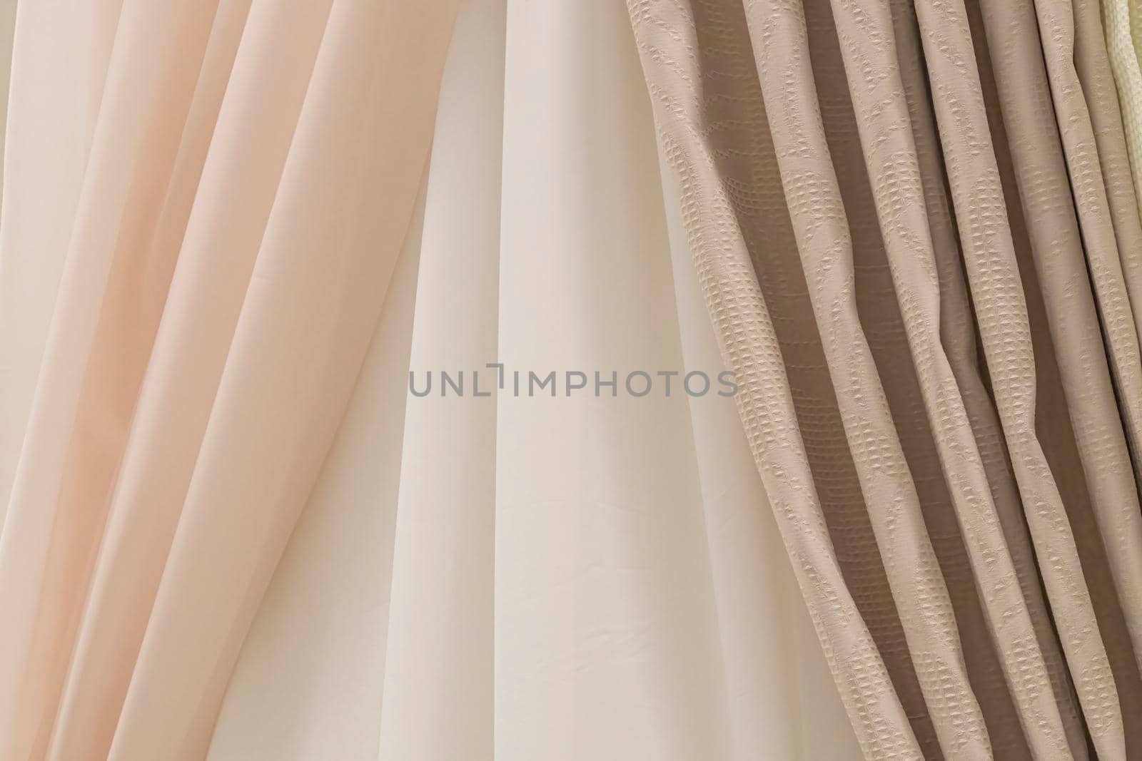 multicolored textures of fabrics on the shelves of stores close-up. High quality photo