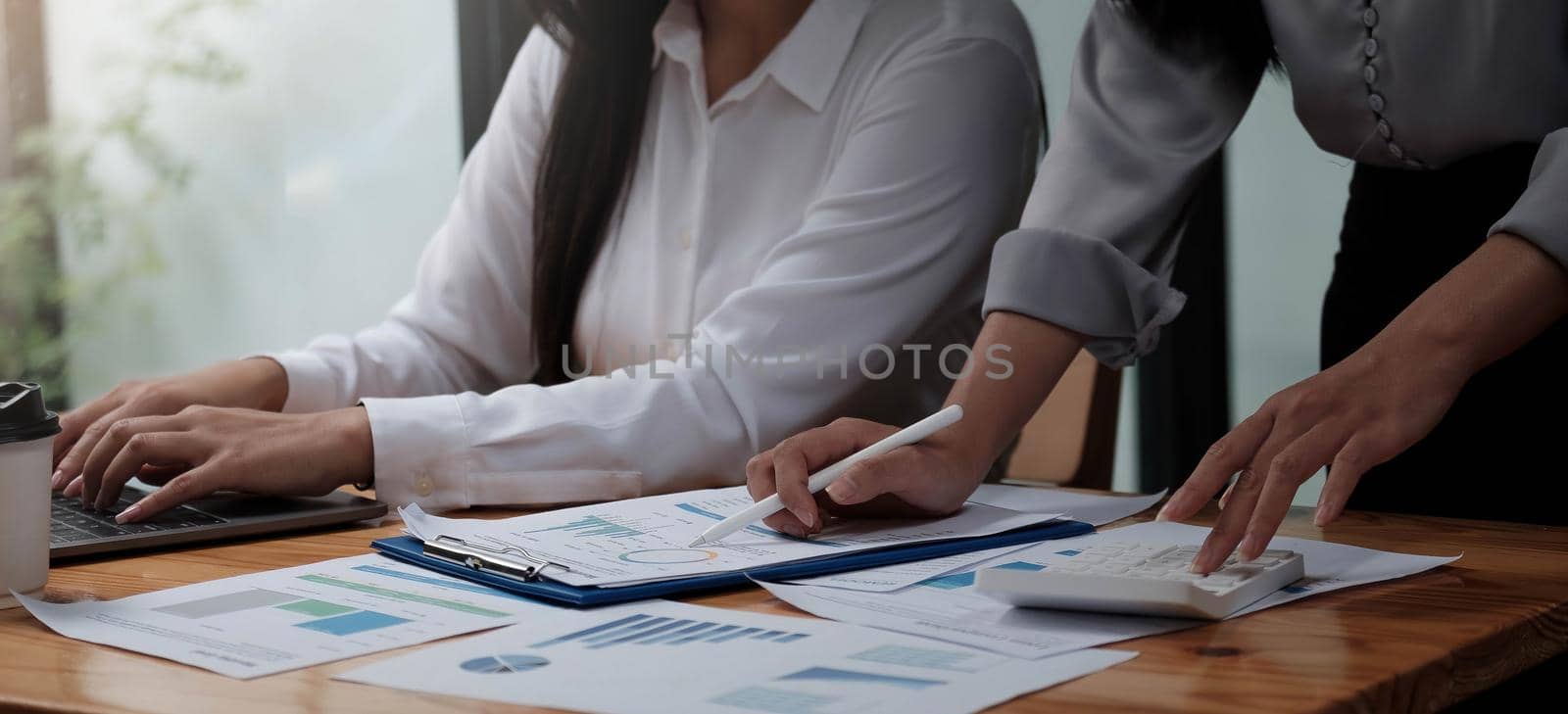 Close up asian business adviser meeting to analyze and discuss the situation on the financial report in the meeting room.Investment Consultant,Financial advisor and accounting concept. by wichayada
