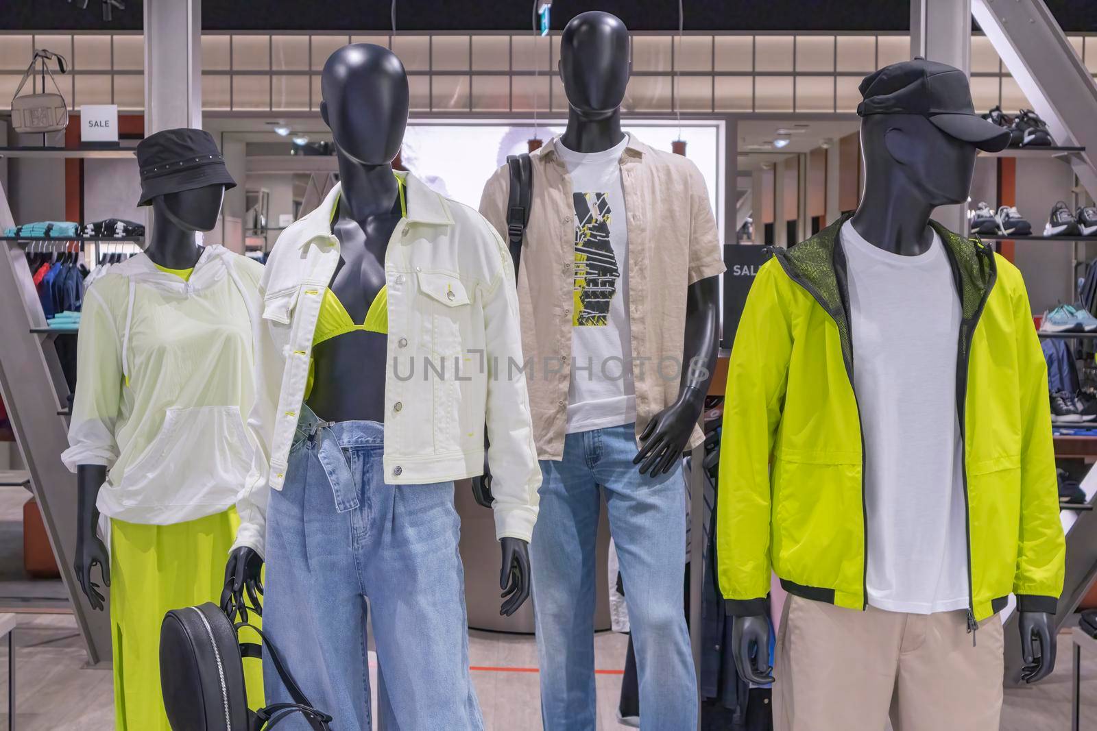 mannequins in a store with the word sale on clothes. High quality photo