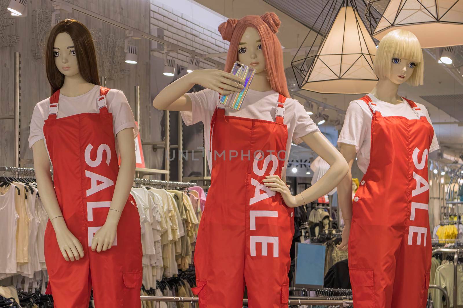 mannequins in a store with the word sale on clothes by roman112007