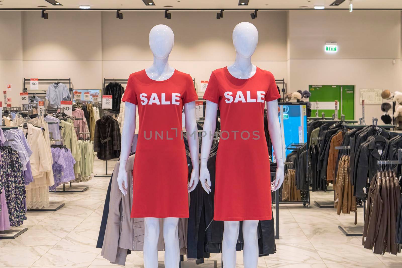 mannequins in a store with the word sale on clothes by roman112007