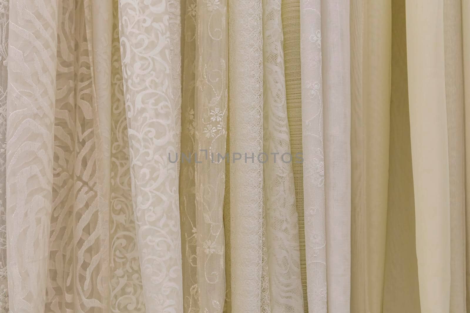 multicolored textures of fabrics on the shelves of stores close-up. High quality photo