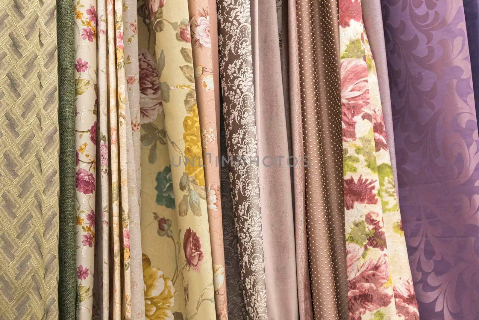 multicolored textures of fabrics on the shelves of stores close-up by roman112007