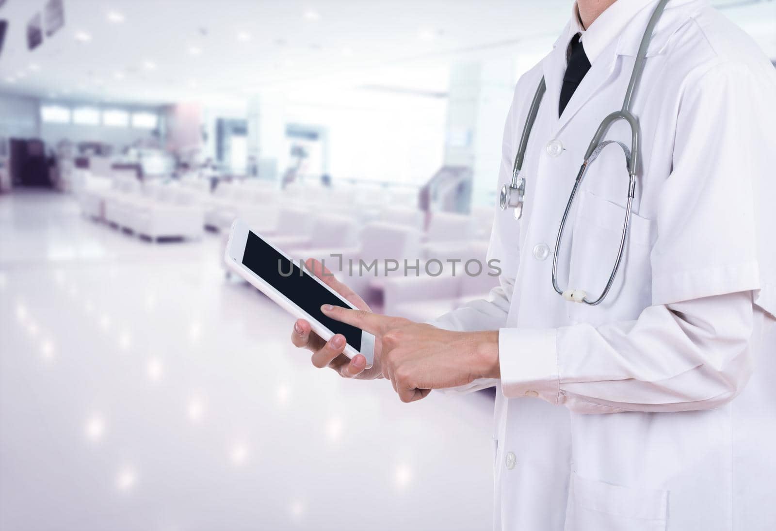 Doctor working on a digital tablet in hospital by geargodz