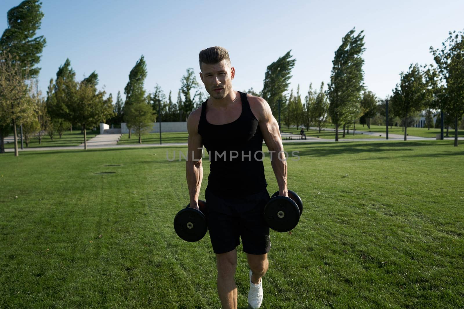 athletic man pumped up body in the park workout fitness fresh air by Vichizh