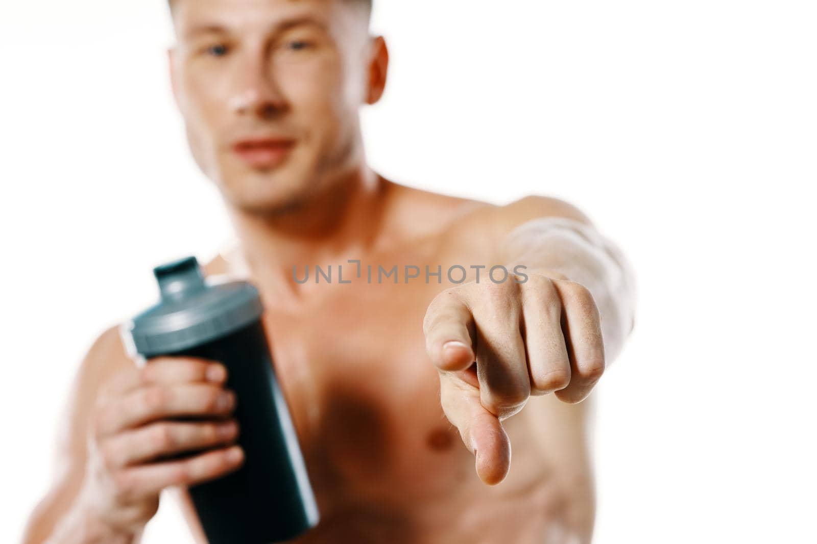 athletic man with a pumped-up torso drink bottle sportspit. High quality photo