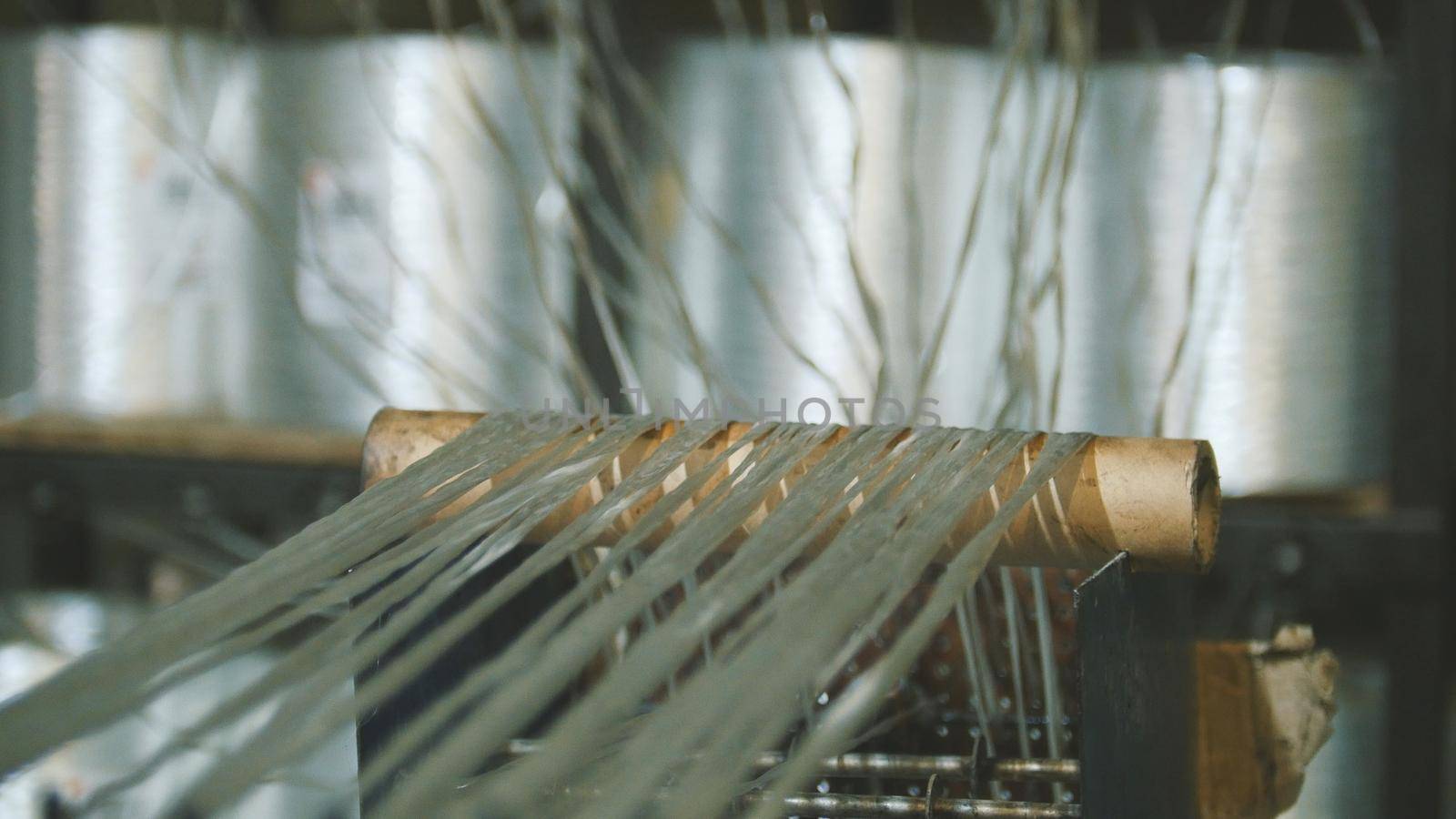 Producing fiberglass rods - manufacture of composite reinforcement, industry for construction, close up