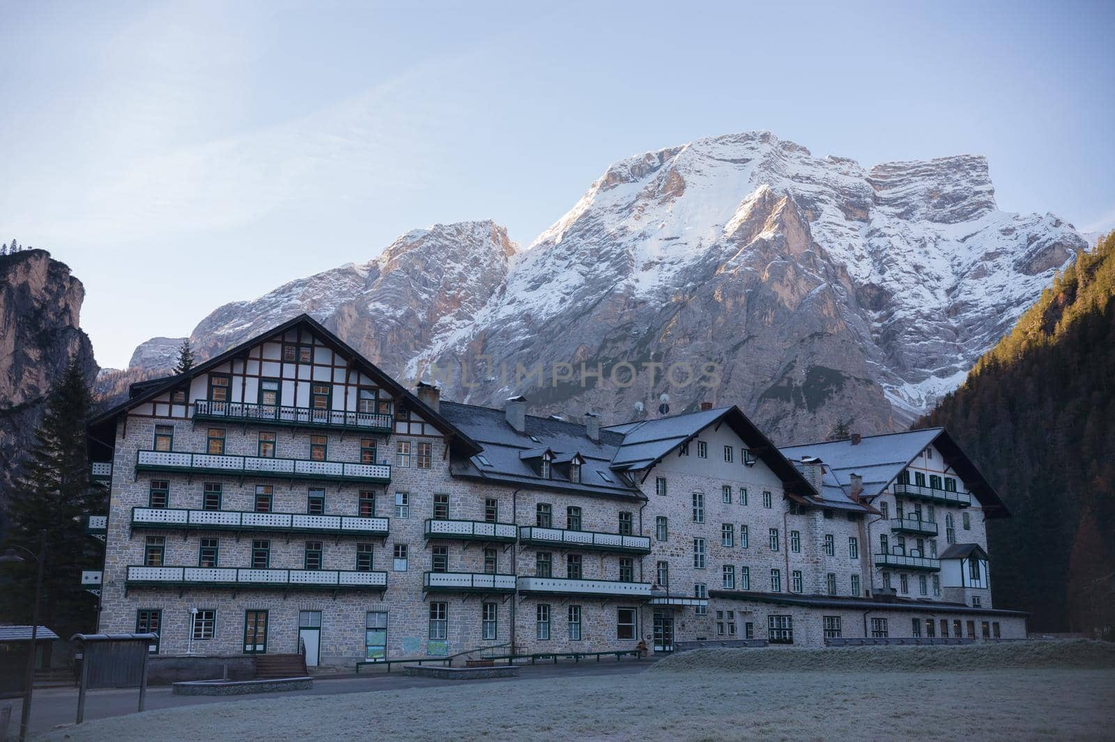 Dolomites. A beautiful house with a huge mountains on a background. Mid shot