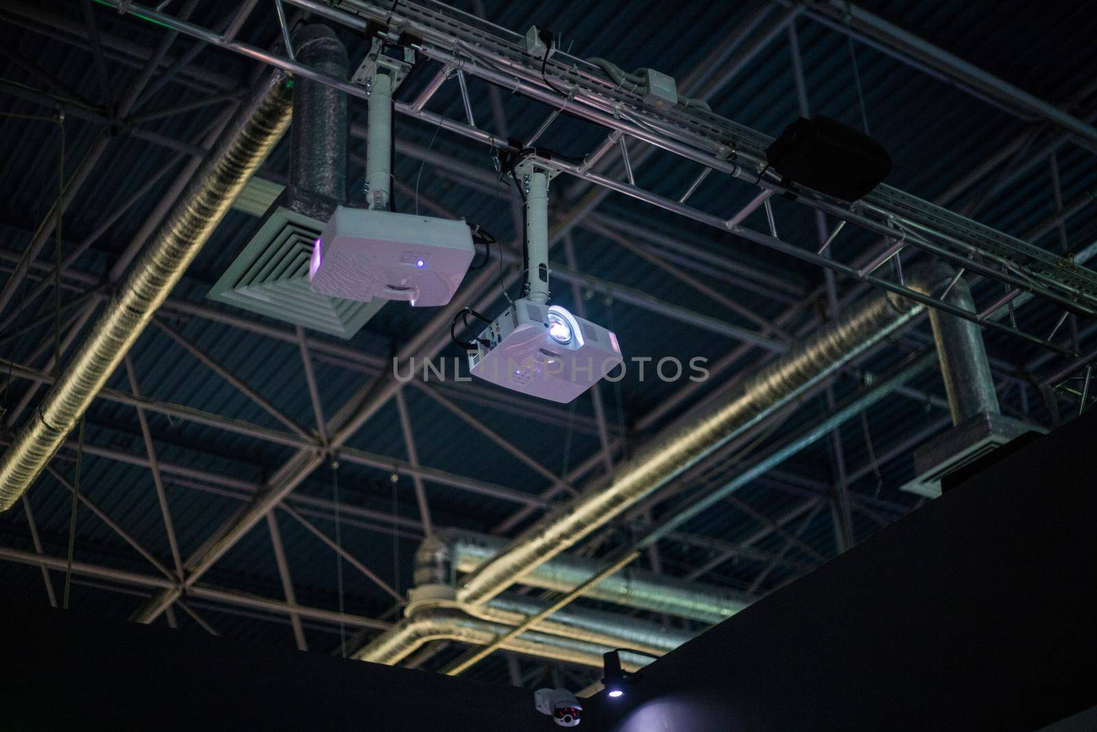 White projector is on the ceiling at the factory. Industrial equipment.