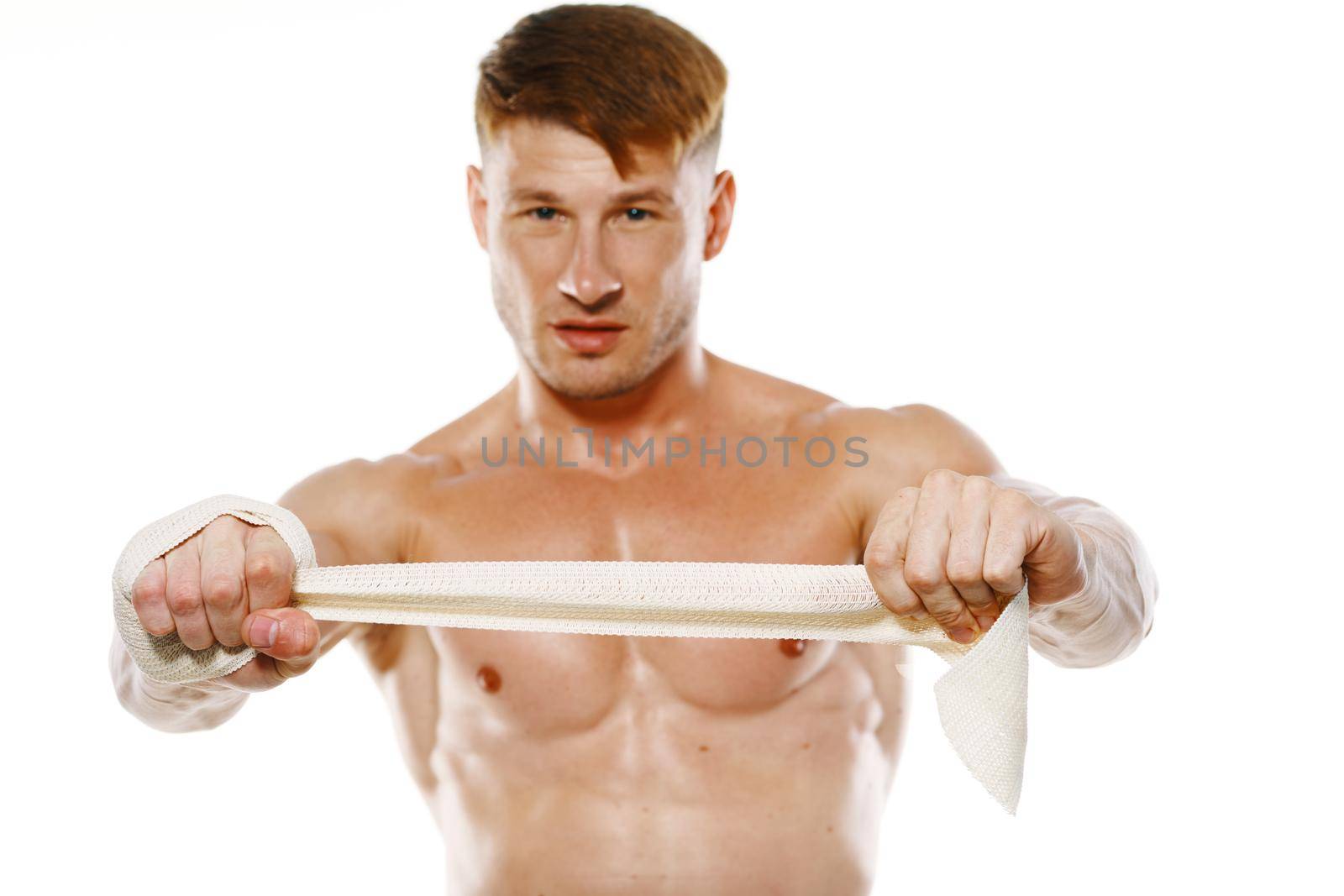 athletic male muscled naked torso boxer fitness exercise bandaged arm. High quality photo