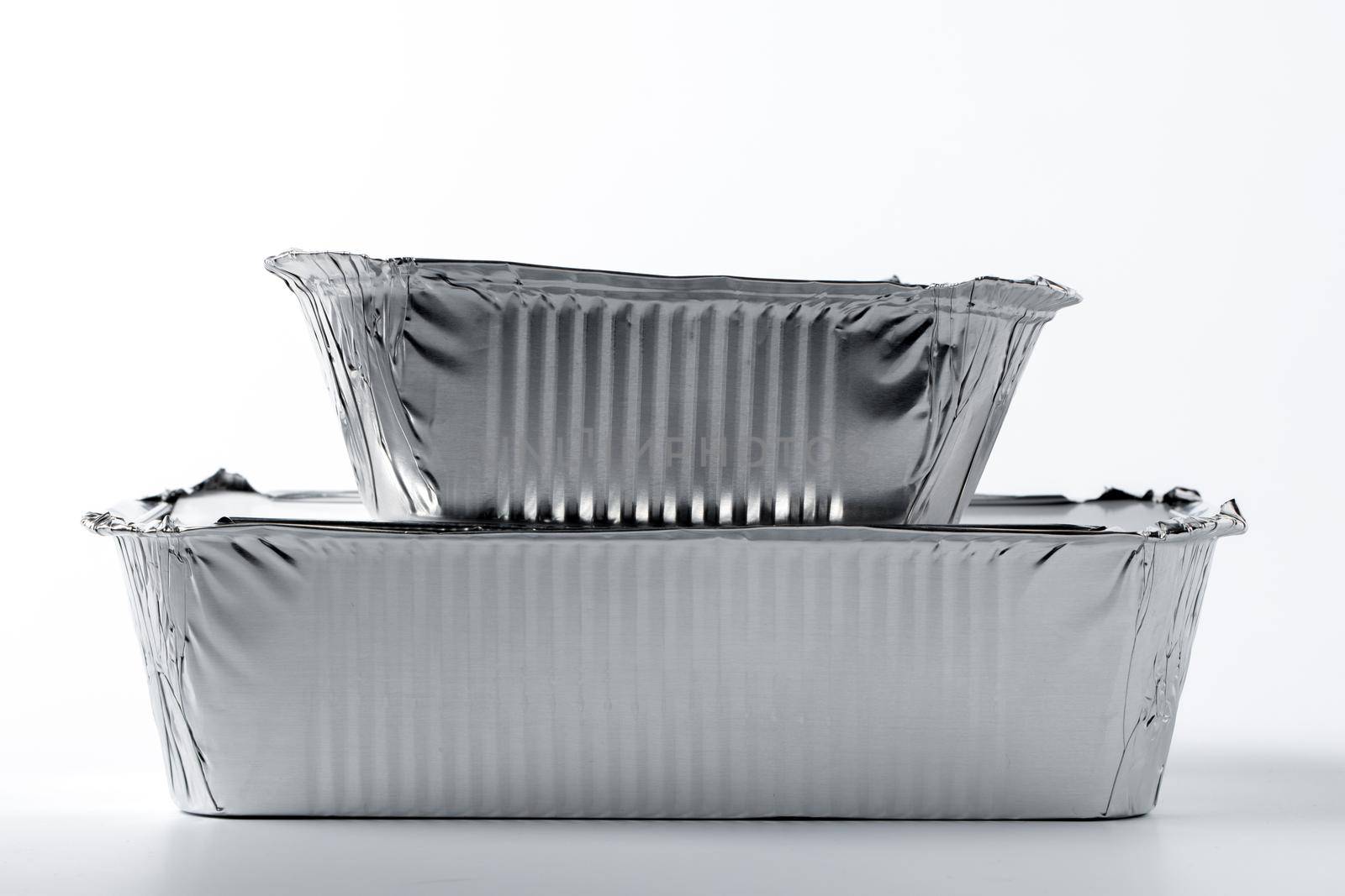 Foil food box with takeaway meal on white background close up