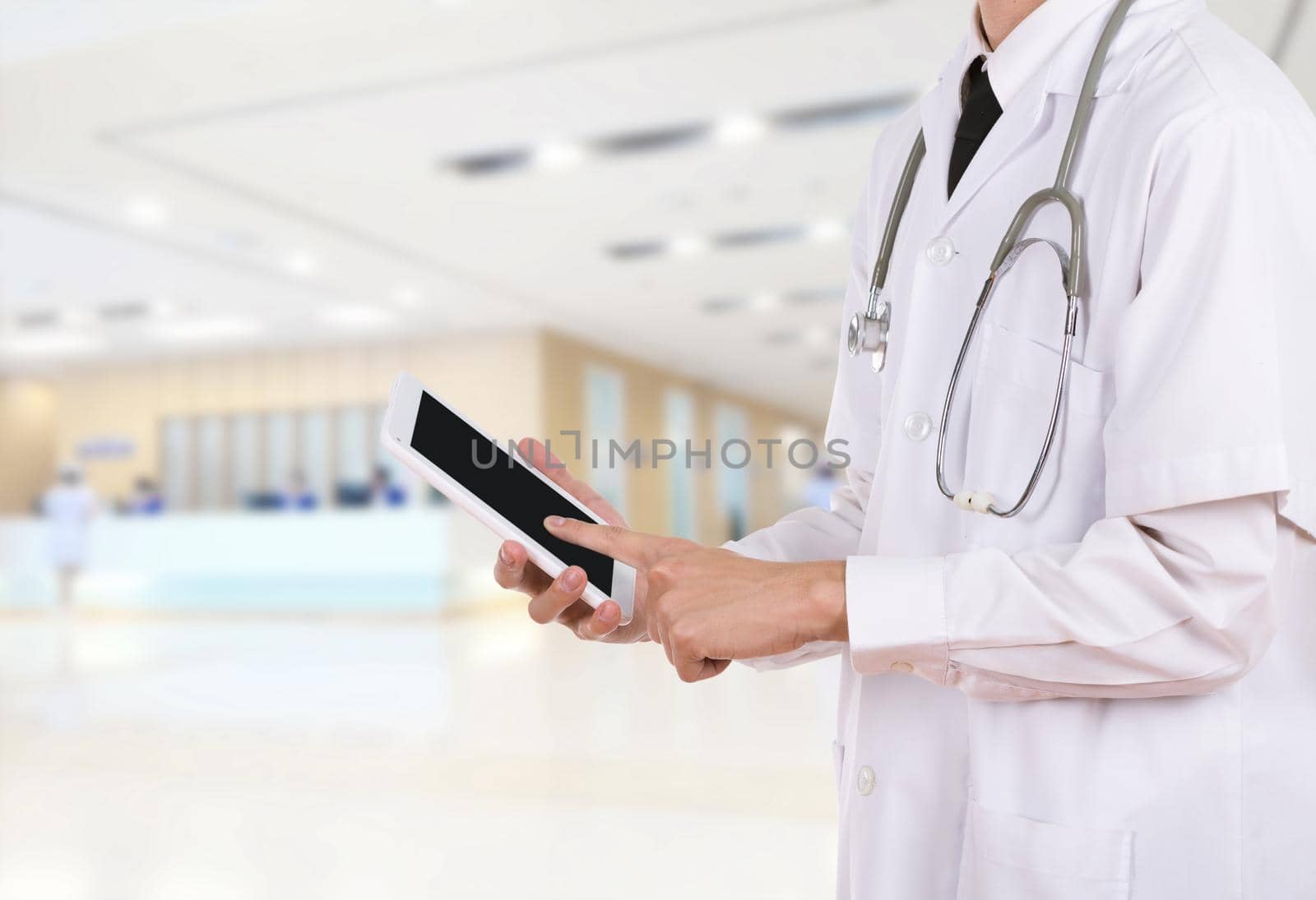 Doctor working on a digital tablet in hospital by geargodz