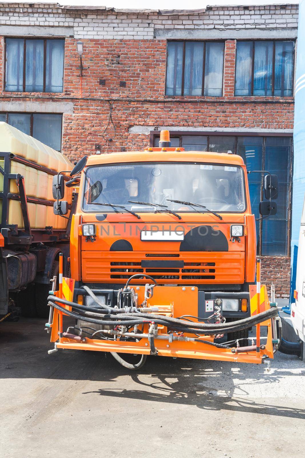 Kamaz truck stands in the parking on brick building background. Wide shot