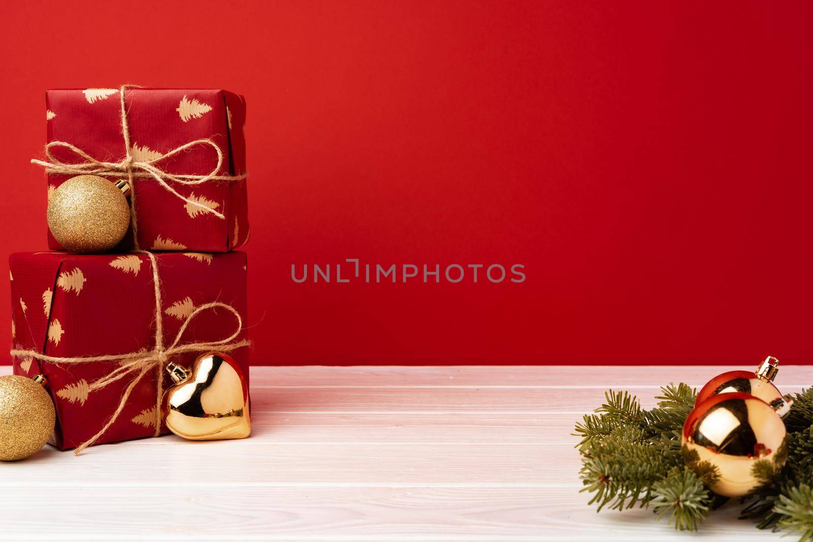 Wrapped christmas gift boxes against red background front view