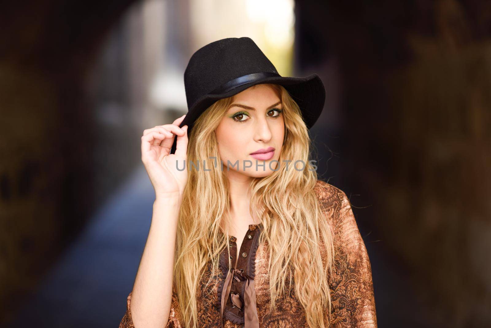 Beautiful young woman with curly hair wearing hat by javiindy