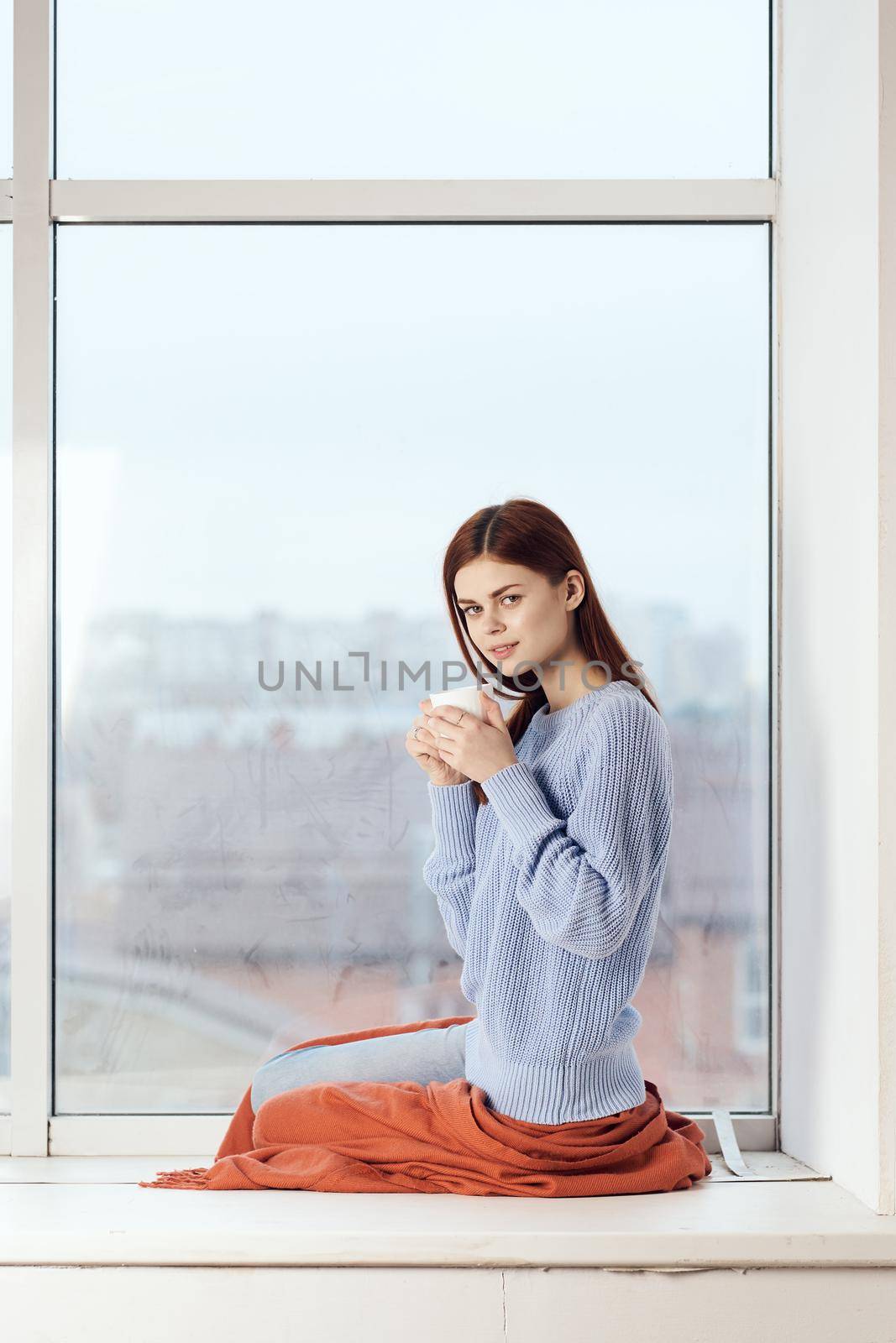 woman near the window dreamy look rest at home comfort. High quality photo