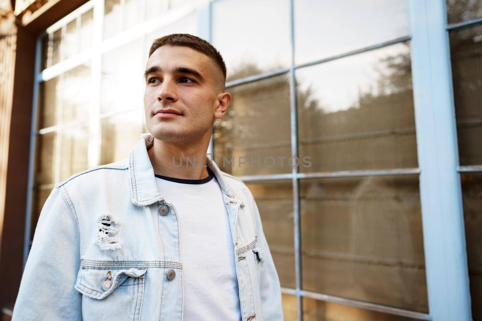 Portrait of handsome young casual man walking on the city street