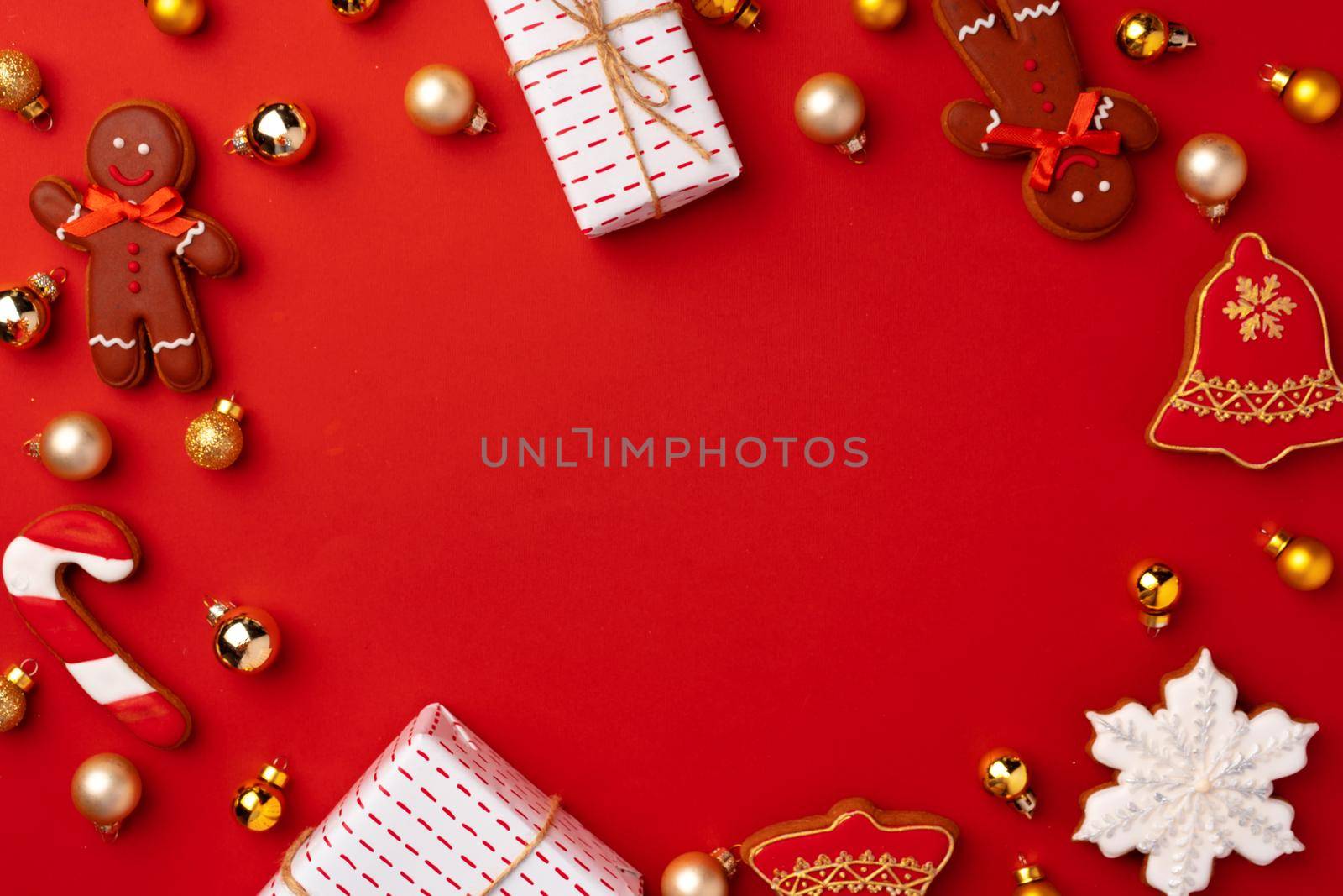 New Year background with festive decorations and gingerbread cookies on red