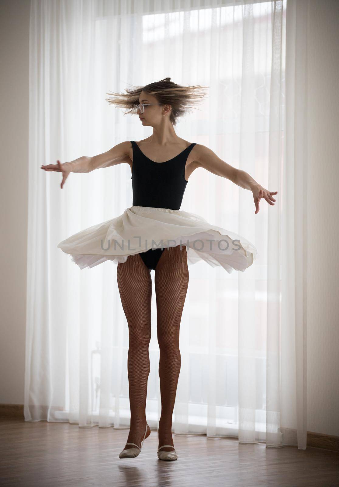 Girl ballerina makes a jump in the studio by Studia72