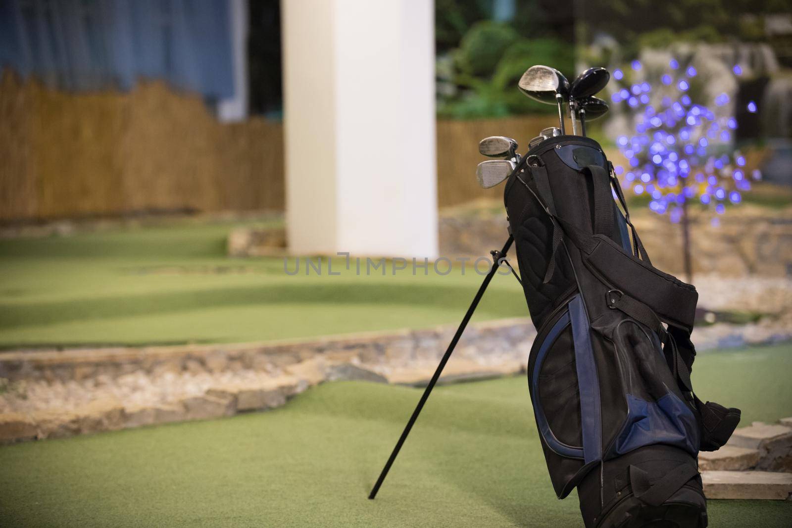 Golf bag golf sticks standing on the golf field by Studia72
