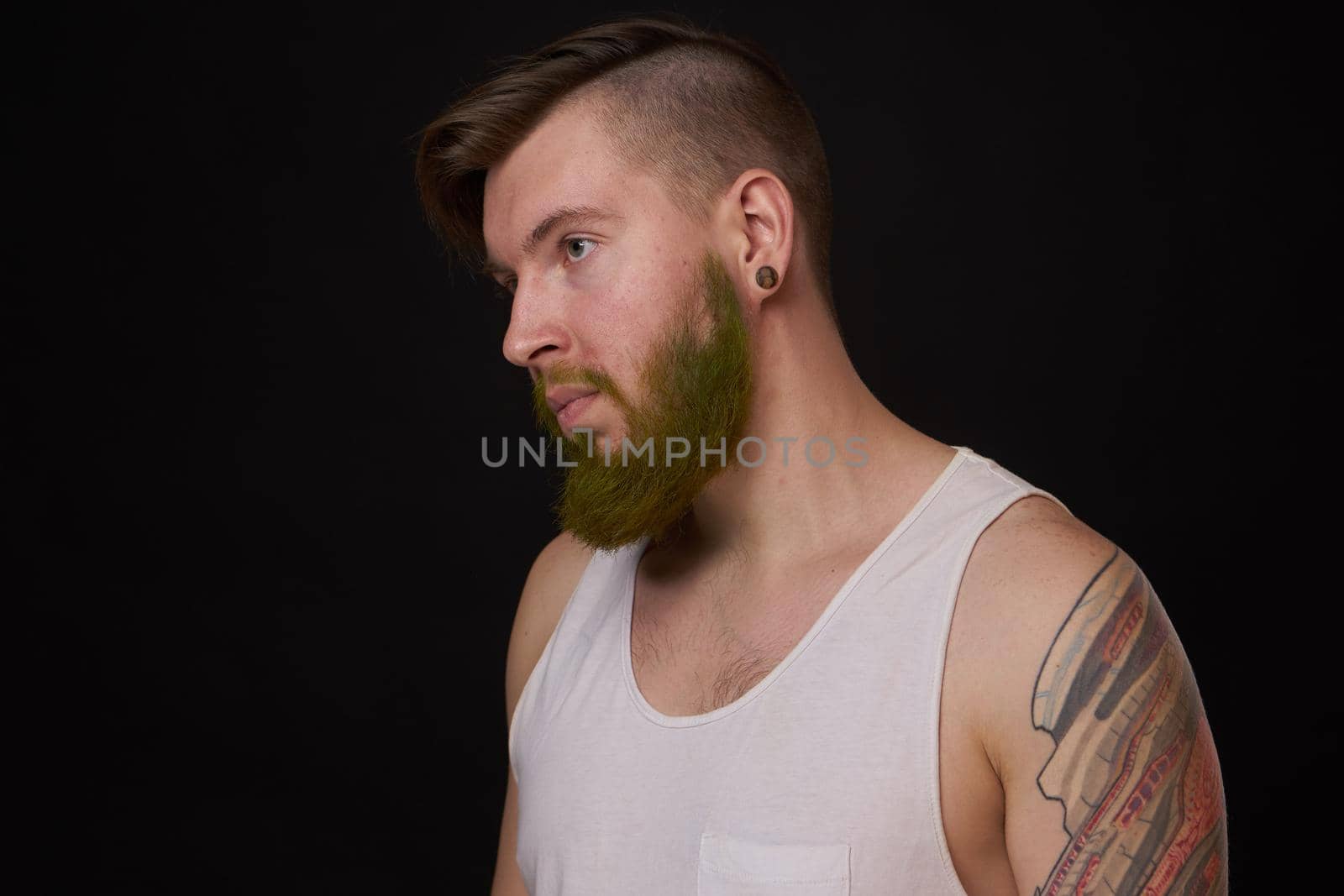 stylish bearded man in a white t-shirt with tattoos on his arms fashion by Vichizh