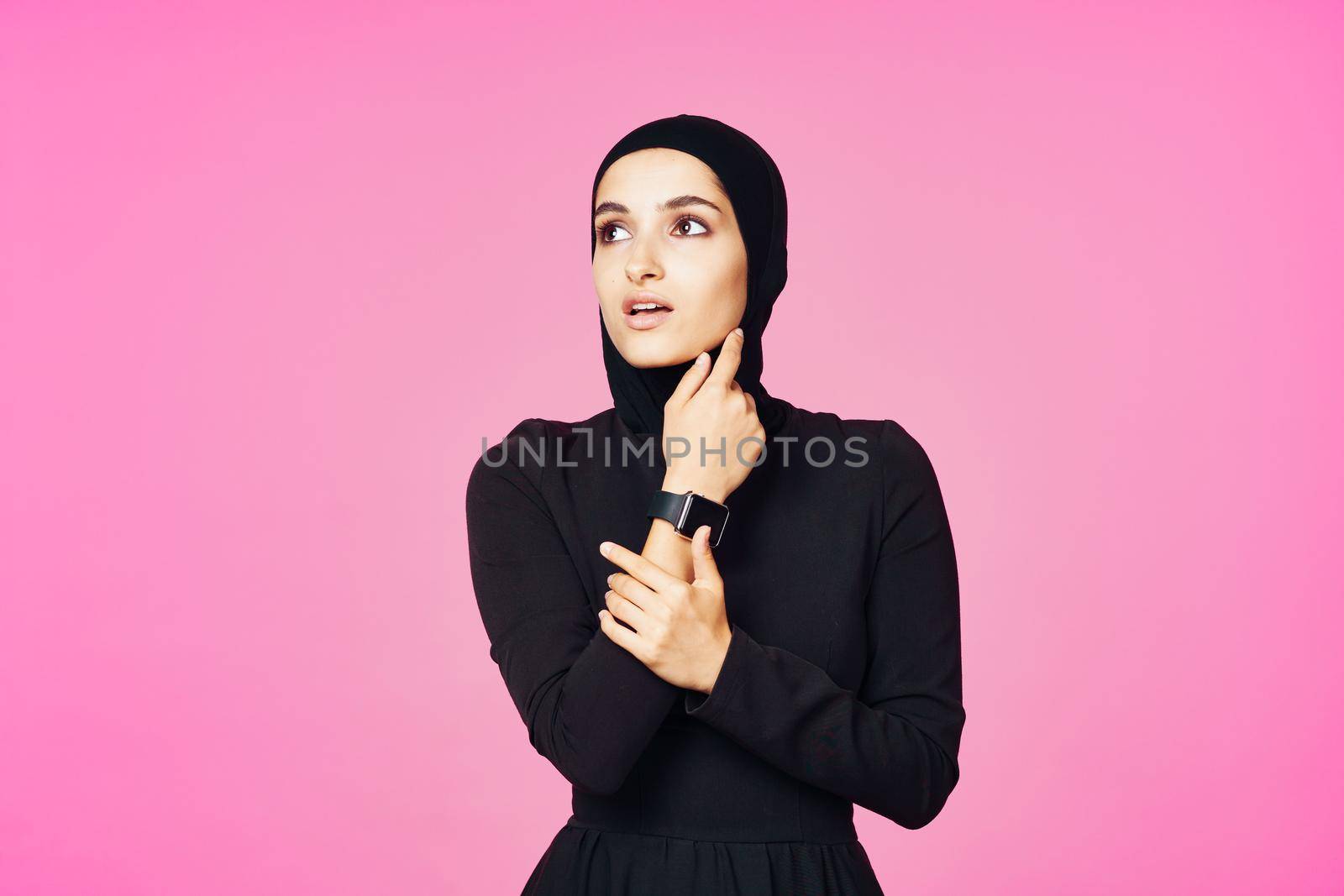 muslim woman in black hijab smart watch technology entertainment. High quality photo