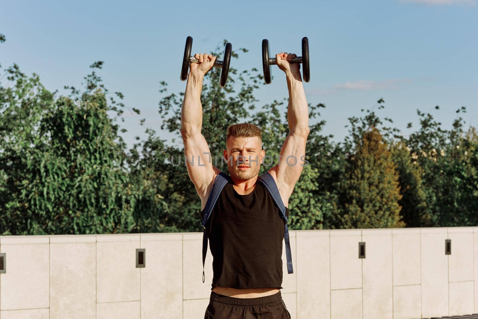 athletic man with dumbbells with pumped up body workout. High quality photo