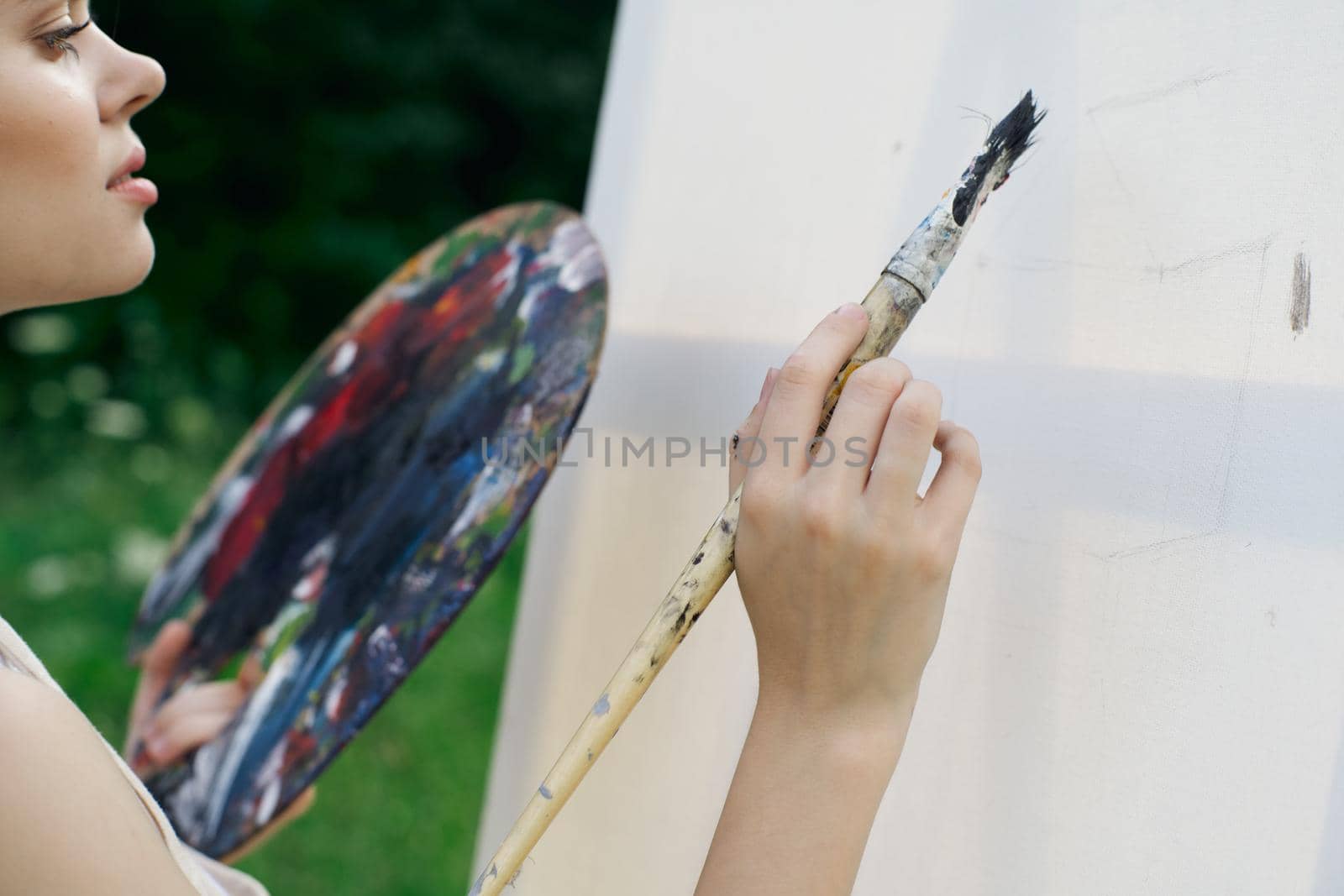 woman artist paints palette easel nature drawing by Vichizh