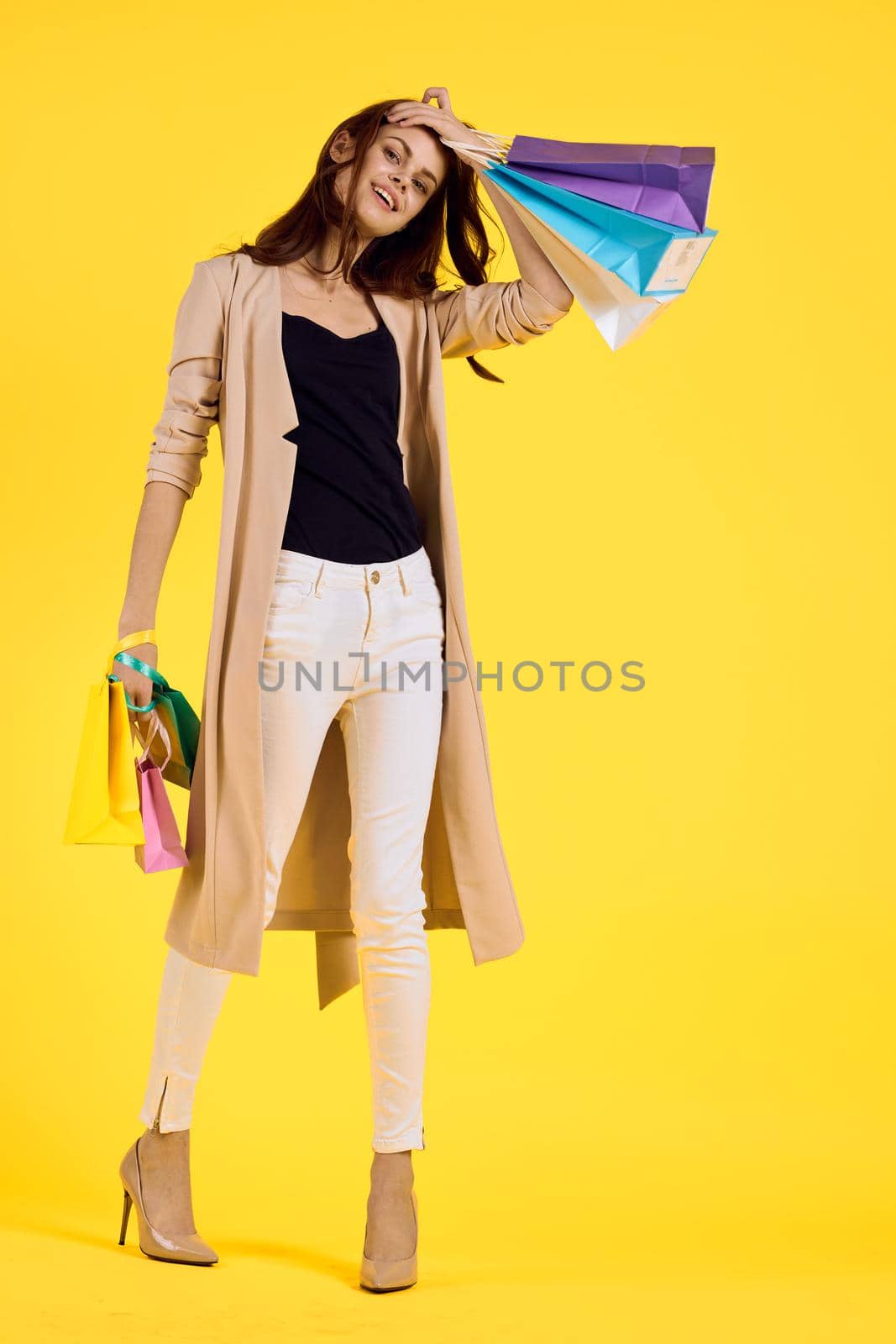 cheerful woman with packages in hands Shopaholic studio model. High quality photo