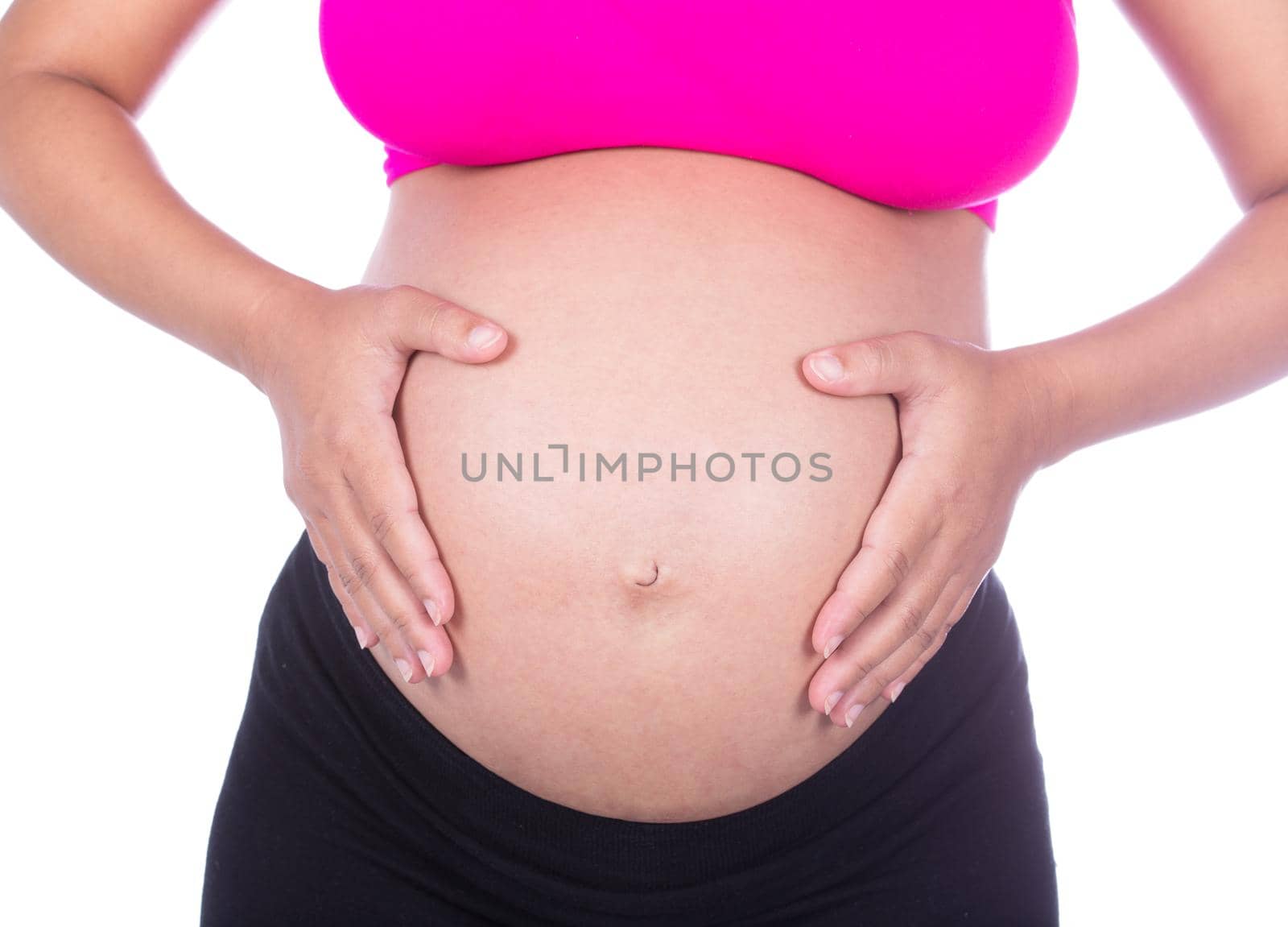 Close-up of pregnant woman belly with her hand on it on white background by geargodz