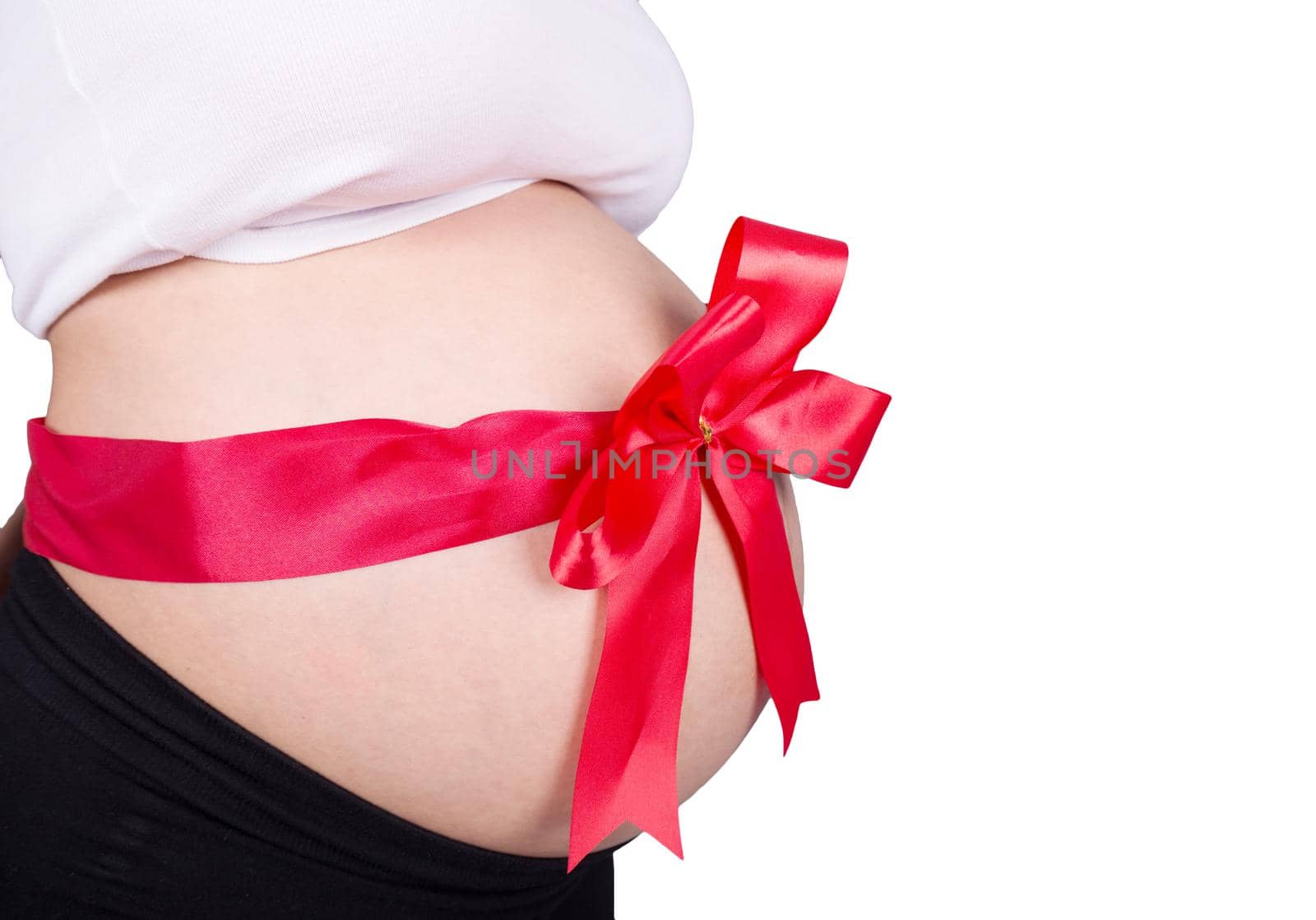 close up pregnant woman with red ribbon gift on belly isolated on white  by geargodz