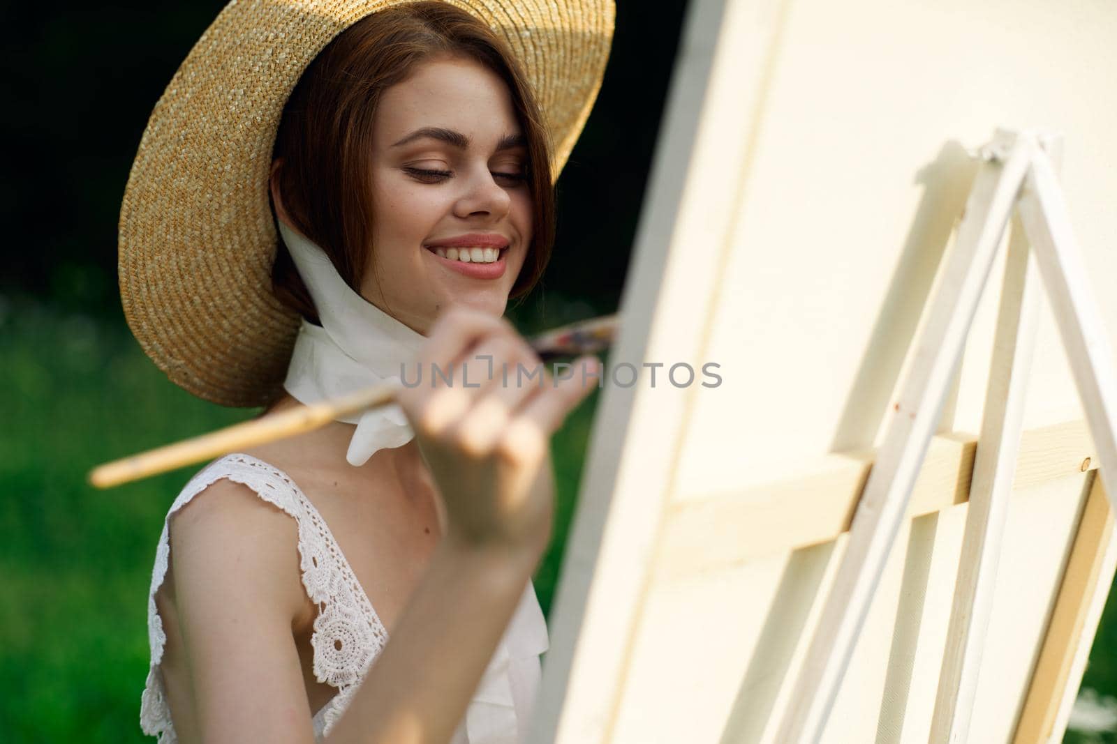 woman artist paints a picture outdoors easel creative. High quality photo