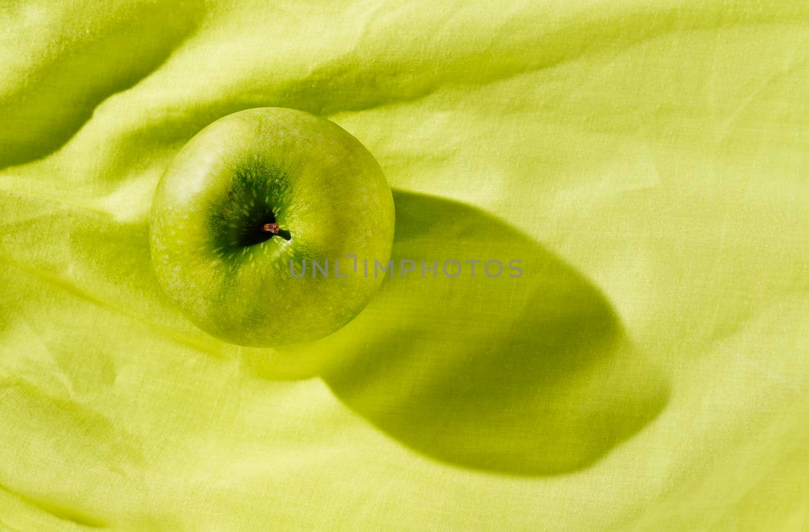 Green apple on green background by victimewalker