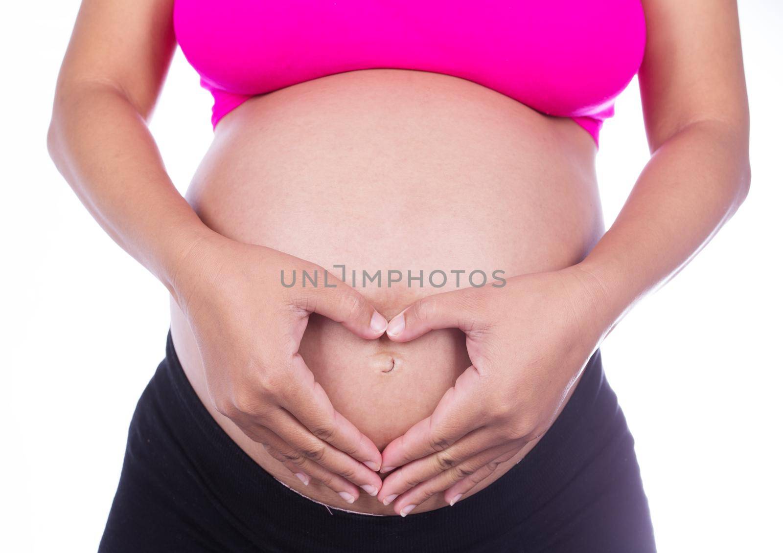 Pregnant Belly of woman with fingers Heart shape isolated on white background