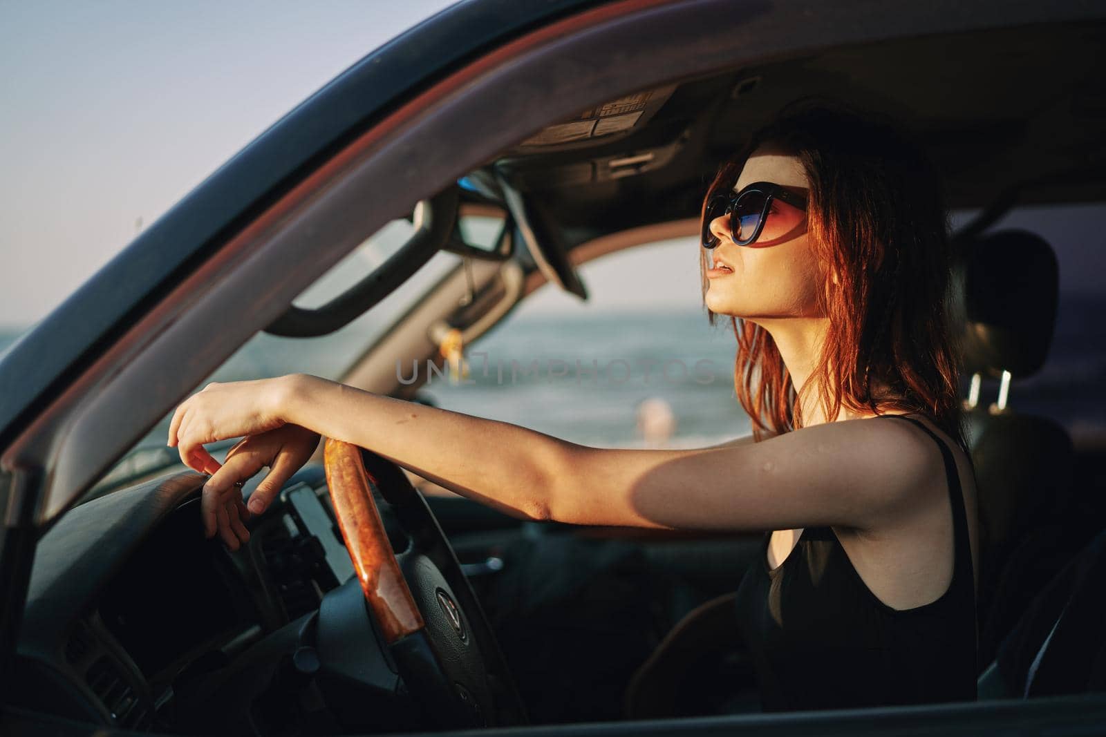 pretty woman in sunglasses driving a car trip. High quality photo