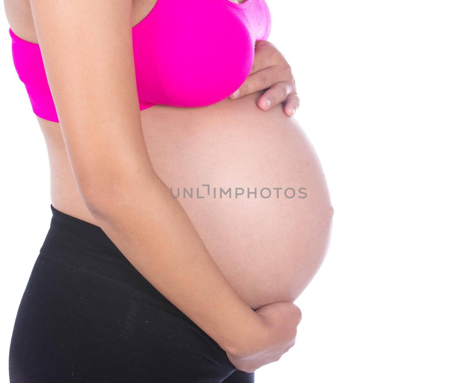 Close-up of pregnant woman belly with her hand on it on white background by geargodz