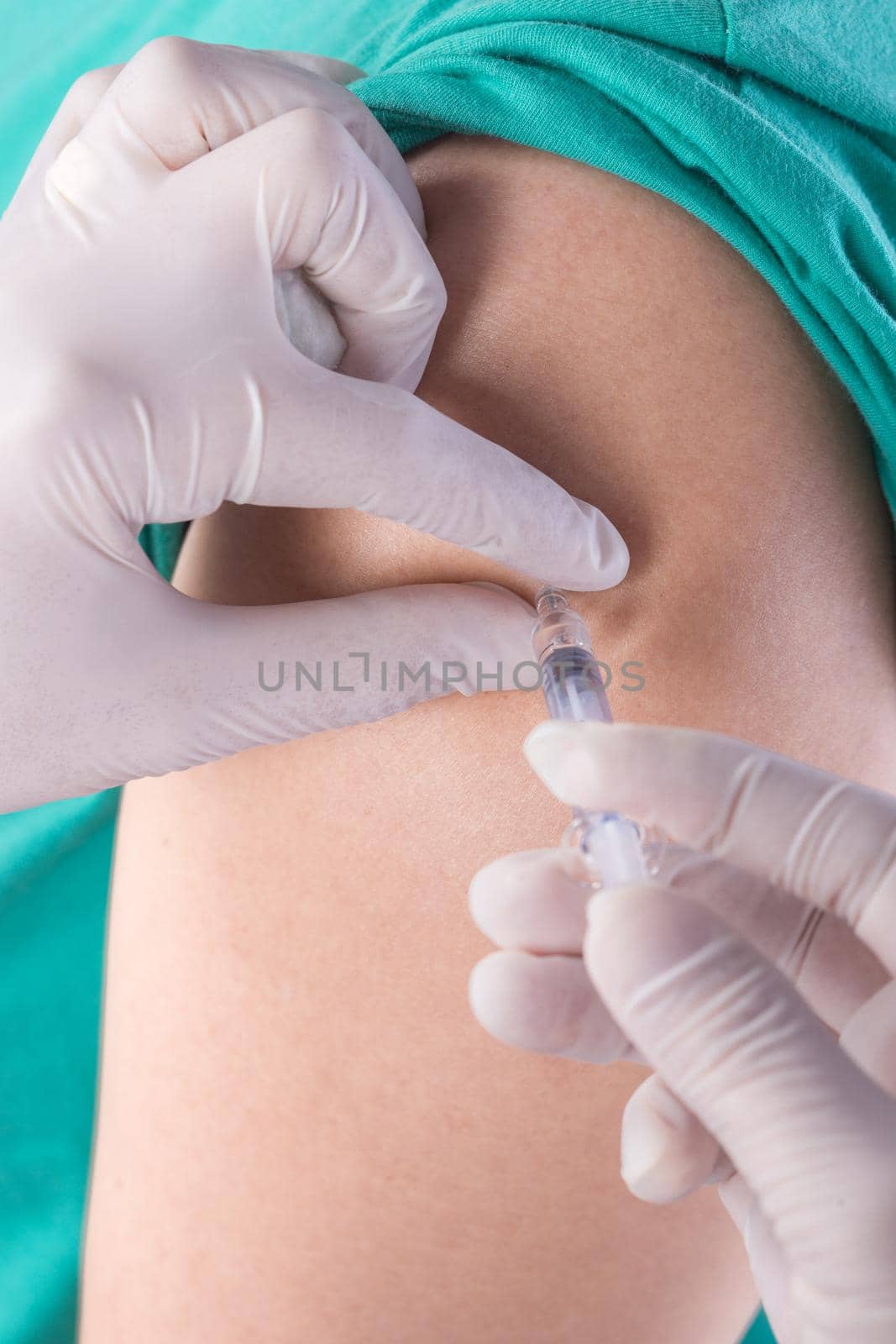 nurse with syringe giving a vaccine for a patient on white background