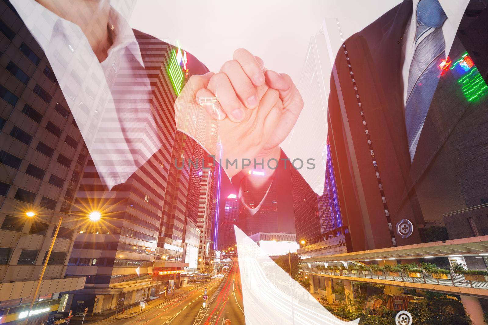 double exposure of arm wrestling between businessman and businesswoman with city background by geargodz