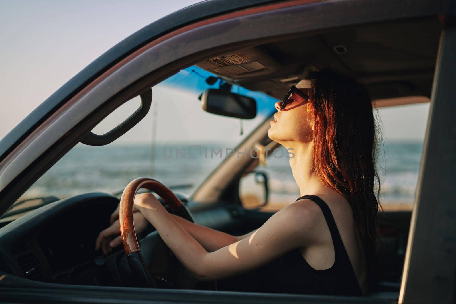 pretty woman in sunglasses driving a car trip. High quality photo