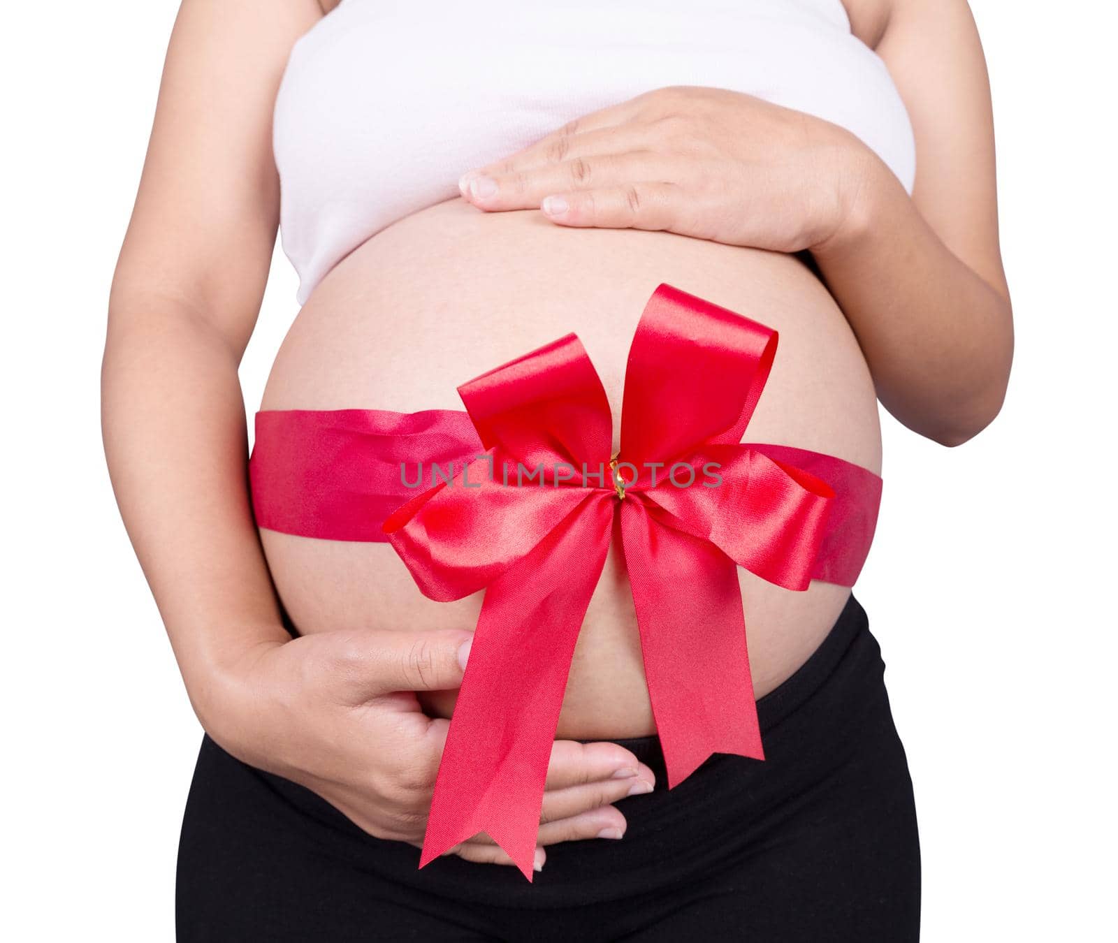 close up pregnant woman with red ribbon gift on belly isolated on white background