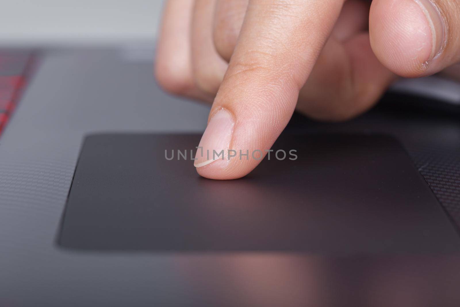 business hand working on a laptop touchpad by geargodz