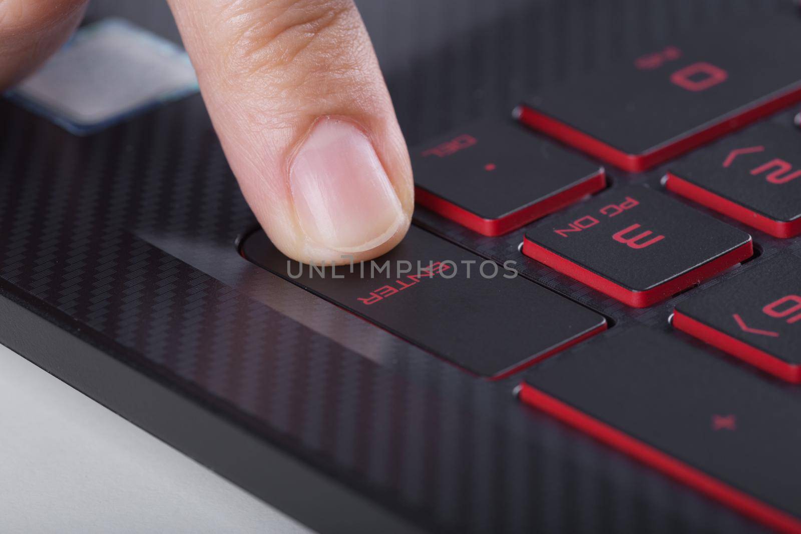 finger pushing enter button on laptop keyboard by geargodz