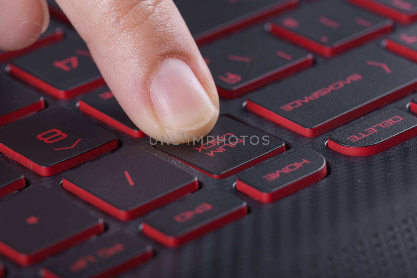 finger pushing num lock button on laptop keyboard by geargodz