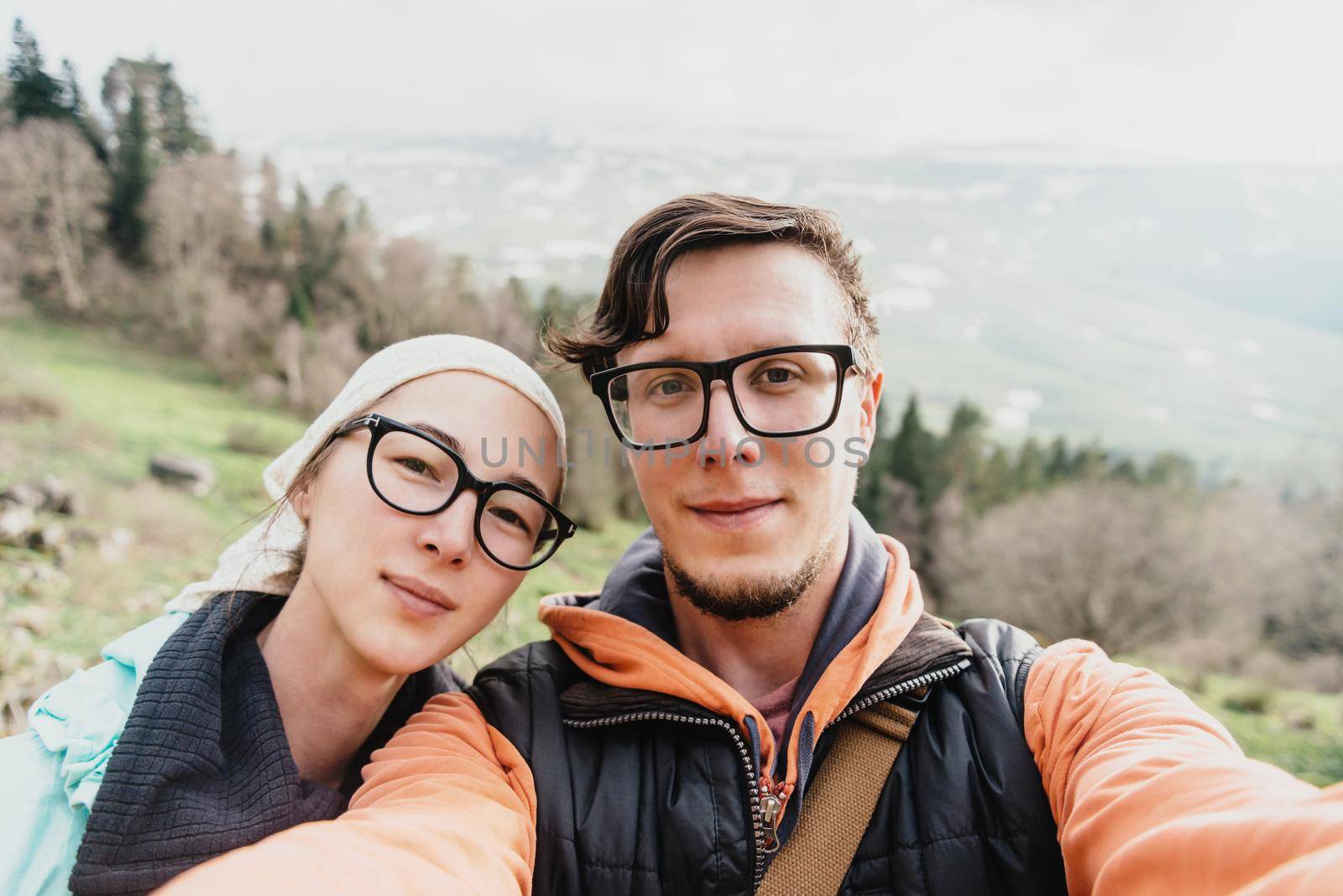 Hiker young loving couple doing selfie in the mountains