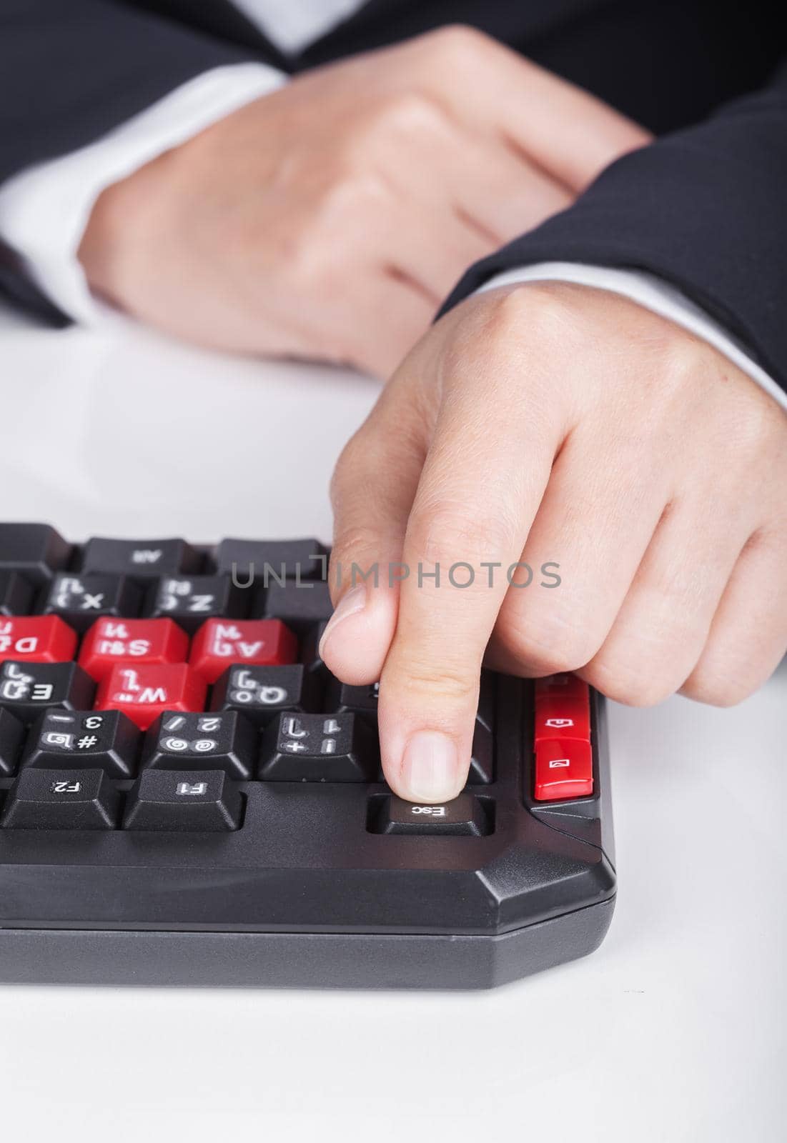 finger pushing ESC button on a keyboard of computer