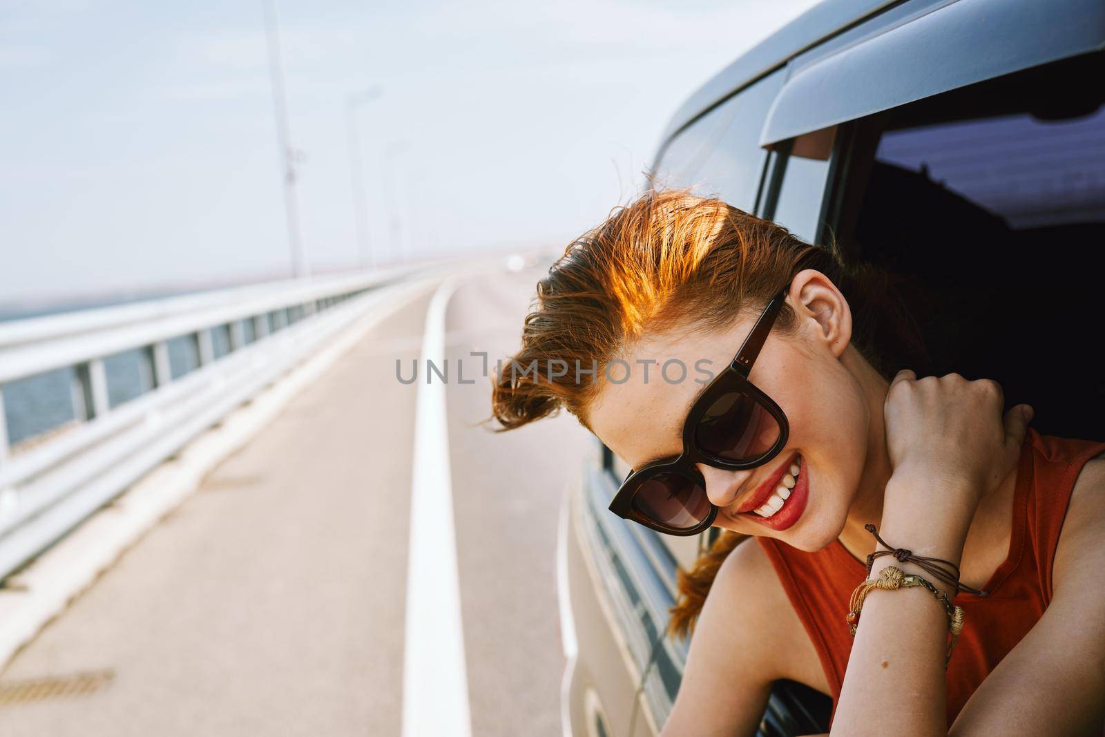 pretty woman in sunglasses rides in a travel car. High quality photo